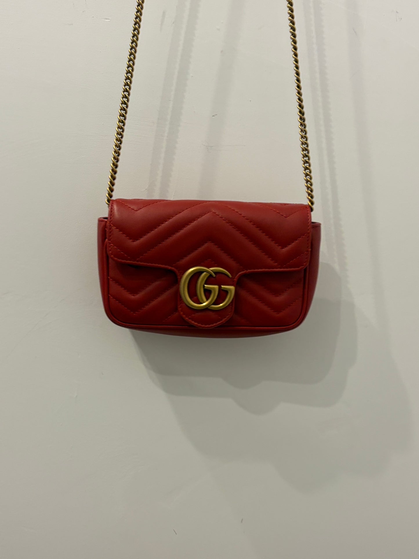 Gucci GG Marmont Super Mini Chain Shoulder Bag in Hibiscus Red Matelassé Leather with antique gold hardware