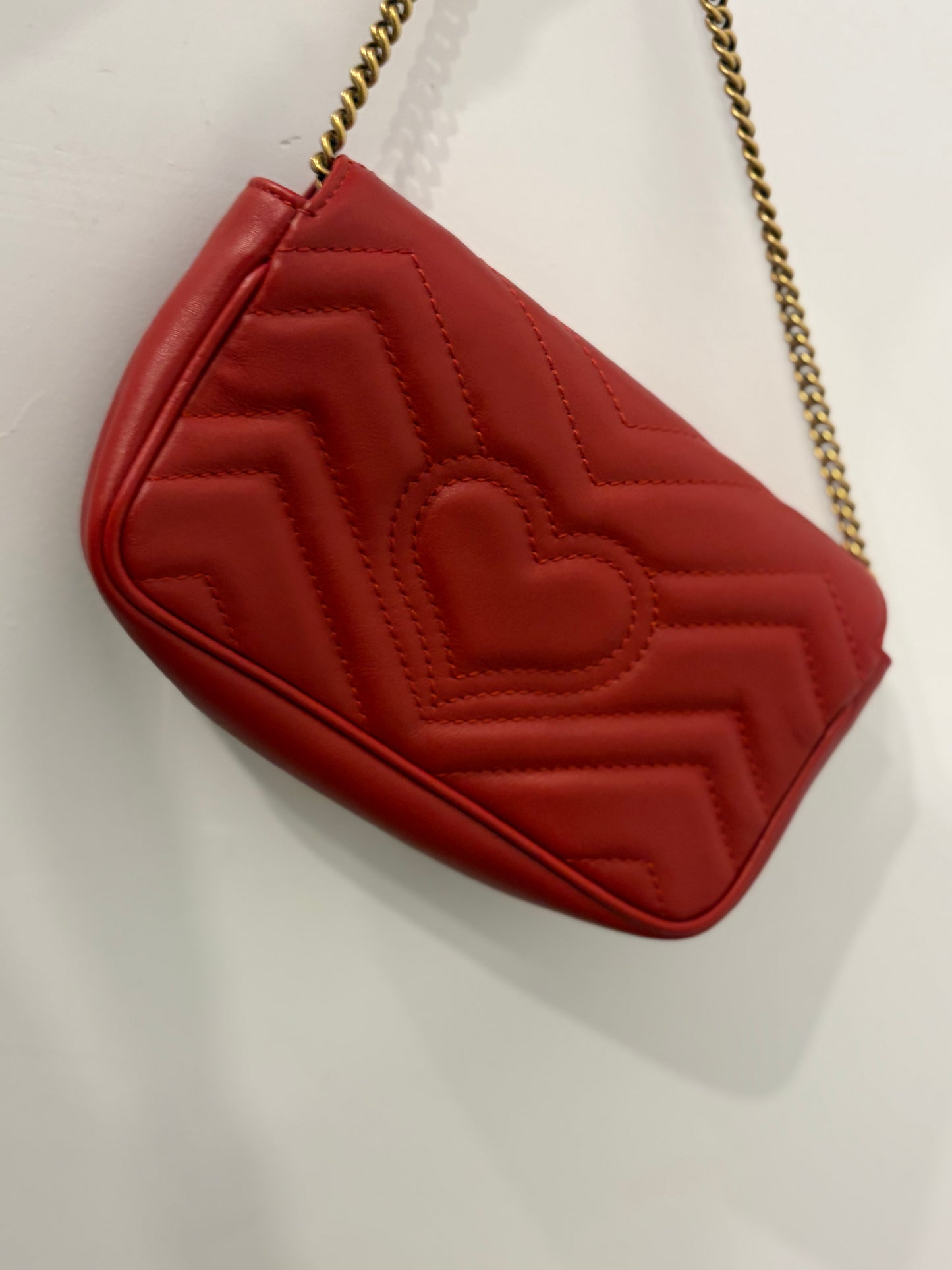 Gucci GG Marmont Super Mini Chain Shoulder Bag in Hibiscus Red Matelassé Leather with antique gold hardware