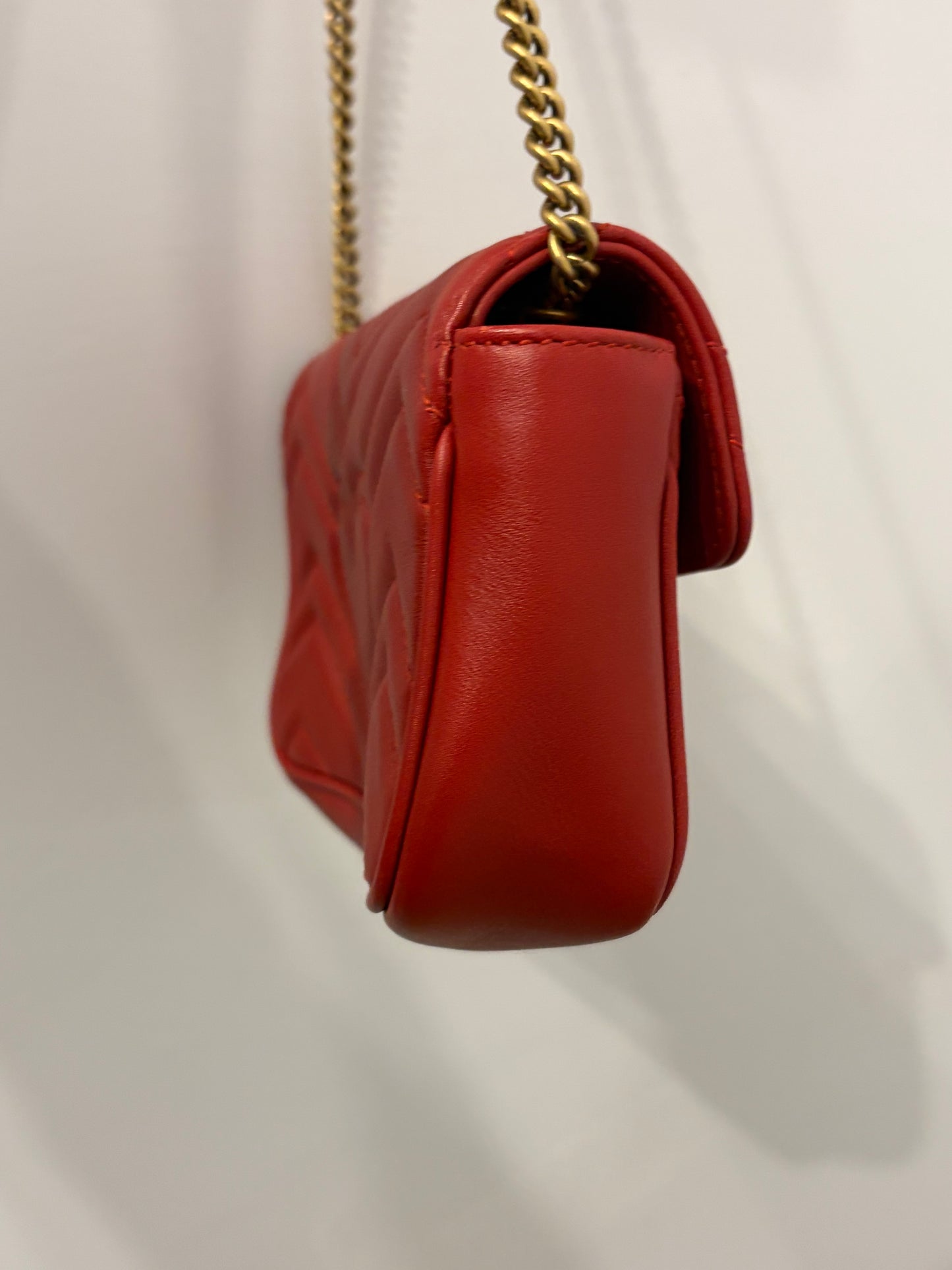 Gucci GG Marmont Super Mini Chain Shoulder Bag in Hibiscus Red Matelassé Leather with antique gold hardware